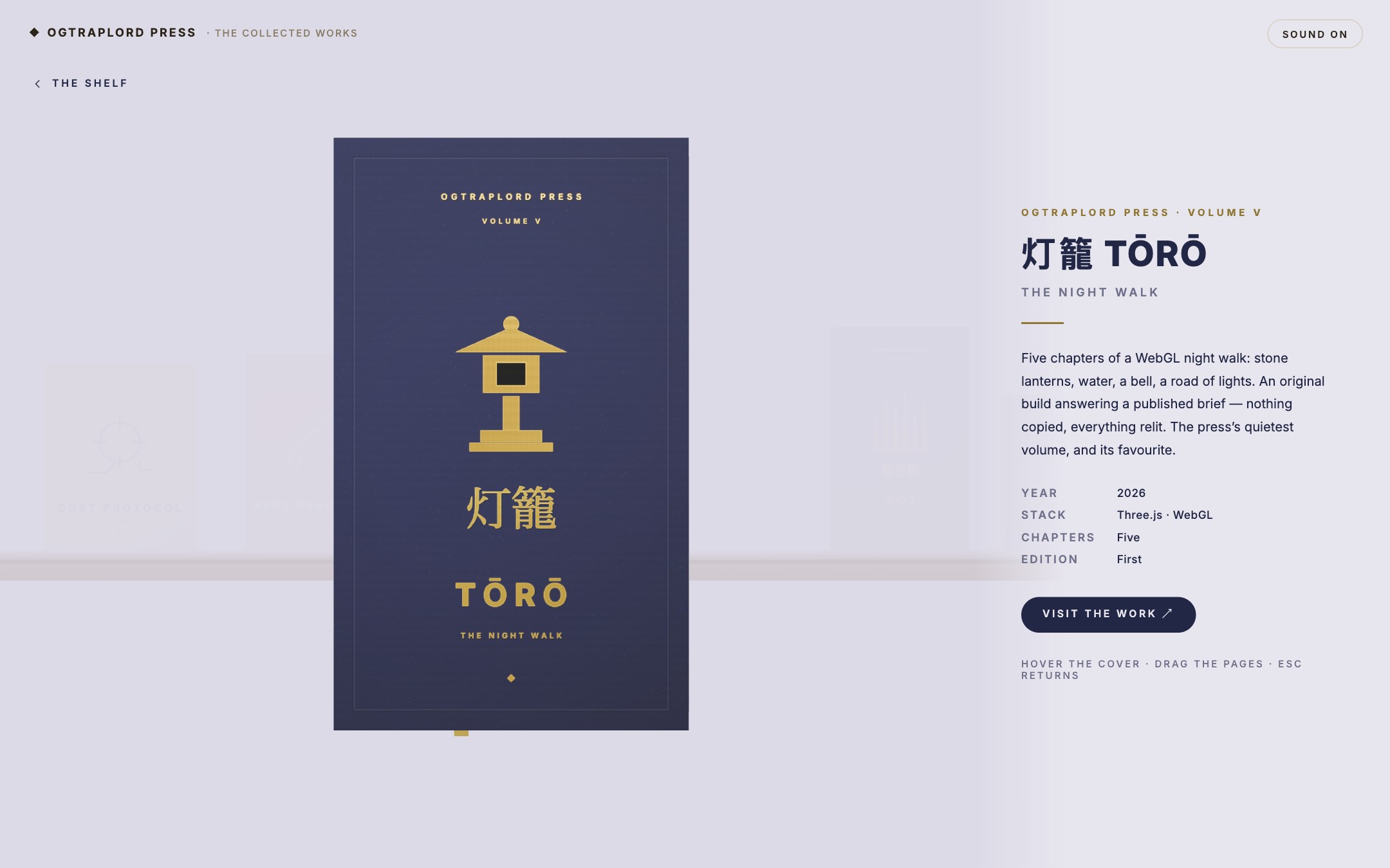 OGTRAPLORD PRESS &mdash; Volume V in detail &mdash; the closed book beside its editorial panel, the whole room rethemed indigo