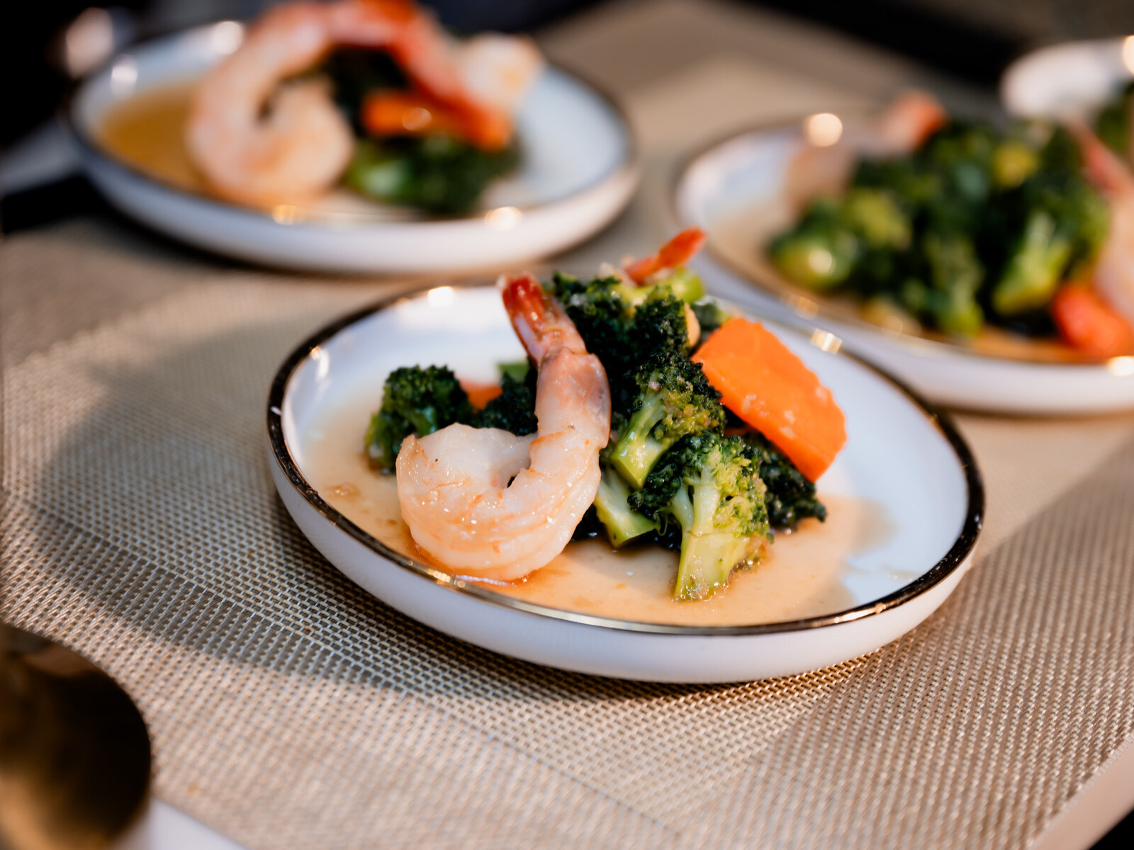 A shared spread of dishes plated to share across the table